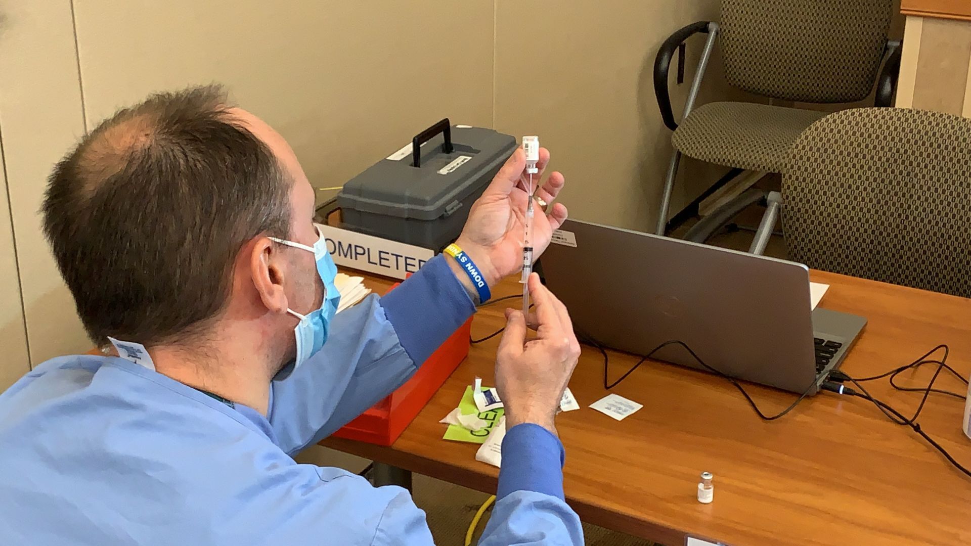 Mike Gillard, pharmacist at Ascension Franklin, prepares a COVID-19 vaccination Wednesday